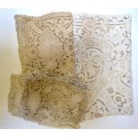 Two boxes containing cut-worked and embroidered table cloth and place mats,