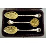 A Victorian cased set of two berry spoons and matching sifter ladle - the spoons of Georgian origin,
