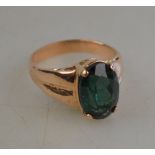 A blue/green doublet single stone ring in four claw setting