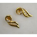 A pair of diamond stud earrings having detachable diamond set scroll drops,