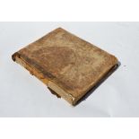 An early 19th century half calf and oil board volume containing a quantity of manuscript music for