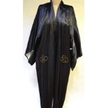 A gentleman's black satin kimono with belt profusely decorated to back with dragon and temples in