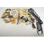 A collection of vintage and contemporary fashion jewellery including necklaces, paste set brooches,