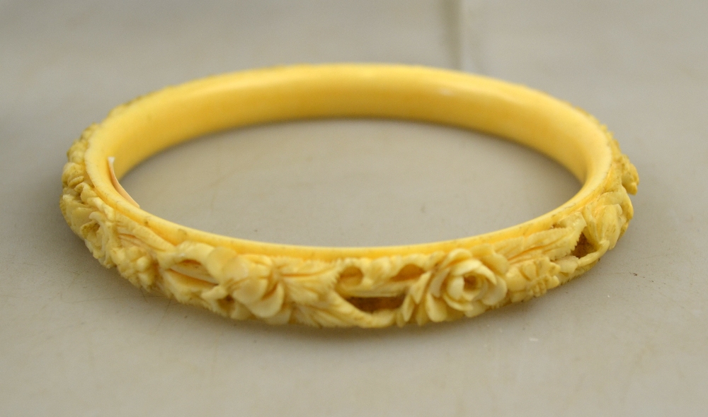 A large Chinese Canton ivory bangle carved with flowers and foliage, 10 cm dia. - Image 2 of 2