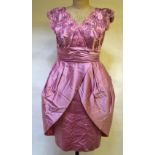 A 1950's dusky rose satin evening dress with boned bodice profusely beaded and sequinned with ruched