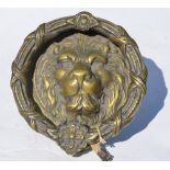 A large and heavy cast brass door knocker with lion mask and ring,