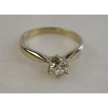 A single stone brilliant cut diamond ring in white metal high claw setting Condition Report