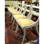 A set of six Regency painted beech cane seat side chairs having upholstered seat pads,