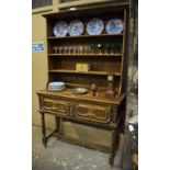 A 17th century style oak low dresser,