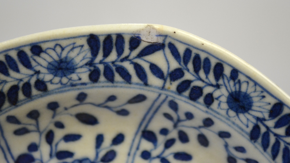 A Chinese blue and white moulded saucer decorated with panels of foliage, Kangxi four character mark - Image 4 of 4