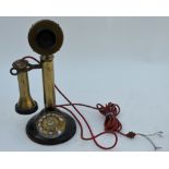 A US patent vintage brass and composite candlestick telephone with dial