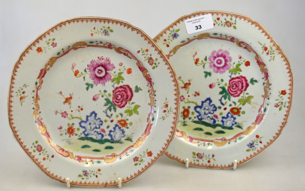 A pair of Chinese famille rose porcelain plates decorated with flowers, foliage and rockwork, 18th