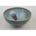 A Chinese Junyao bowl of conical shape covered overall in a pale blue glaze infused with a splash of