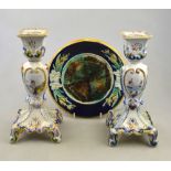 A pair of French faience candlesticks, 24.5 cm to/w a majolica plate, the border moulded with