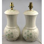 A pair of Belleek table lamps decorated with Shamrocks, 29 cm h. (2) Condition Report Both good