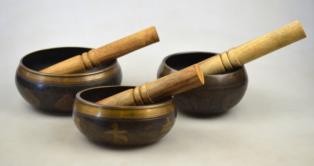 Three Chinese graduated bronze 'singing bowls' decorated with crossed vajra, c.