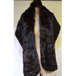 A long dark brown fur stole,