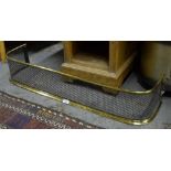 A Regency brass and steel hearth fender with Gothic-pierced grill,