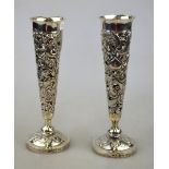 A pair of Chinese export white metal pierced spill vases decorated with dragons chasing flaming