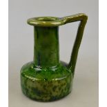 A stoneware Arts & Craft jug in the Christopher Dresser style, deep mottled green glaze, 17.5 cm