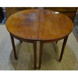 A pair of 19th century mahogany demi-lune tables raised on square legs to brass castors,