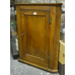 An 18th century mahogany hanging corner cupboard with single panelled door,