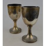 A pair of Victorian silver trophy cups in the form of goblets engraved with the shield and crest