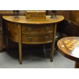 A 19th century crossbanded mahogany demi-lune sideboard having two graduated drawers flanked by