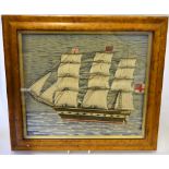 A 19th century woolwork picture of a British Naval man o'war in full sail, 29 x 32 cm,