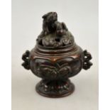 A Japanese bronze incense burner decorated in relief with panels of birds, the reticulated cover