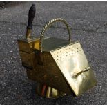 A brass coal box, the hinged slope front enclosing a zinc liner,