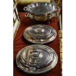 A pair of plated on copper chafing dishes with cast scroll handles and feet,