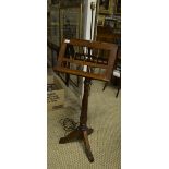 A Victorian Gothic influence oak duet music stand having a rise and fall pole - later illuminated