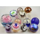 A collection of fourteen paperweights including two Isle of Wight examples (one of miniature size),