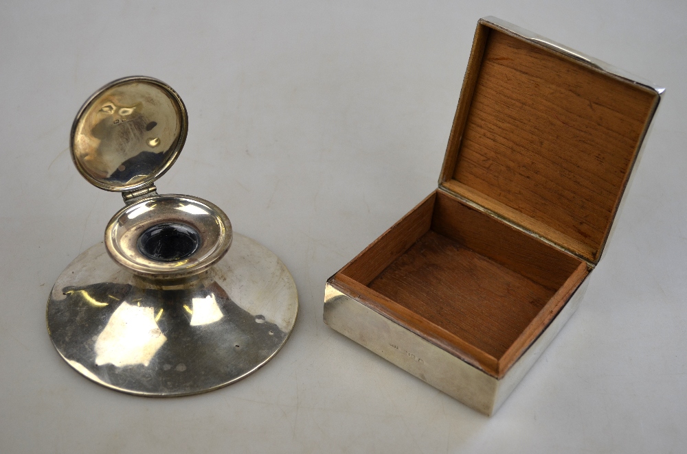 An Edwardian silver capstan inkwell, A & J Zimmerman, Birmingham 1908, to/w a cigarette box,