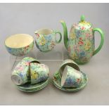 A Shelley chintz 'Melody' pattern coffee set comprising five cups and saucers, sugar basin, cream