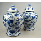 A matched pair of Chinese blue and white porcelain vases and covers each decorated with birds and