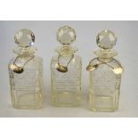 A set of three square cut decanters with spherical facetted stoppers, 8.2 x 8.