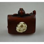 A Japanese wood netsuke carved as a tobacco pouch and kizerizutsu, signed with two character