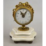 A small French brass drum timepiece with ribbon decoration, enamel dial and Swiss lever movement, on