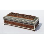 An Indian carved wood, ivory and sandalwood glove-box on metal bun feet,