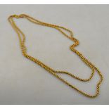 A Victorian yellow metal guard chain stamped 15, of fancy belcher style fitted with bolt chain,