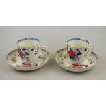 A pair of Chinese famille rose cups and saucers, 18th century, decorated with flowers and foliage,