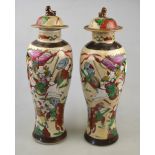 A pair of Chinese crackleware vases and covers decorated with fighting figures, 19th century,