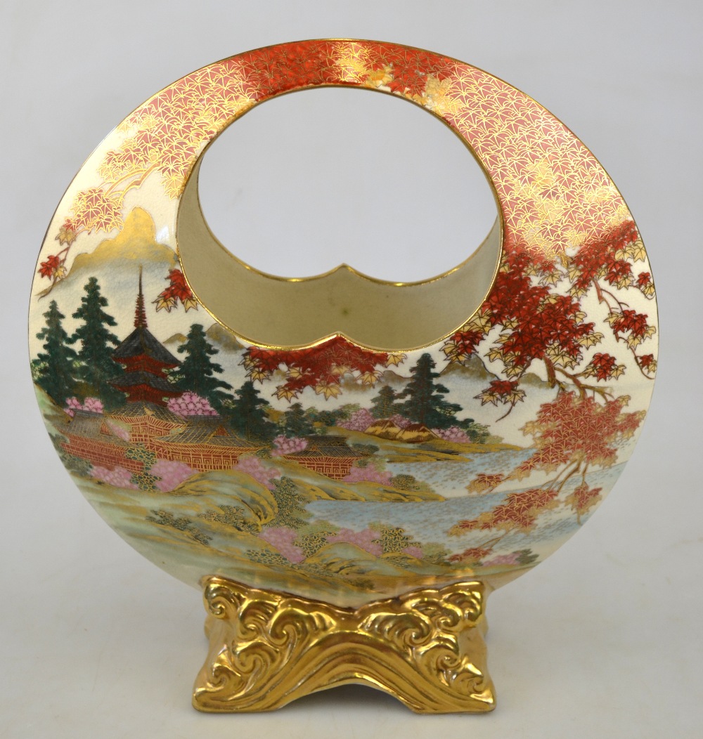 A Japanese Satsuma circular disk shaped vase raised on a gilt base decorated with pagodas in a - Image 2 of 3