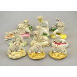 A collection of twelve porcelain 19th century models of poodles, a number seated on pastel