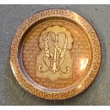 A Hispano-Moresque Spanish copper lustre faience charger decorated with a large monogram to the