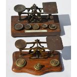 Two sets of brass postage scales with weights