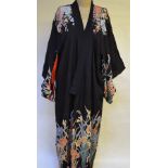 Two 1930's black Japanese kimonos printed with vibrant exotic flowers and lined with silk (2)