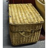 A large vintage wicker linen basket with steel strap handles